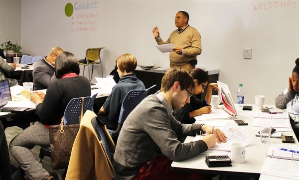 Man teaching students from front of a room